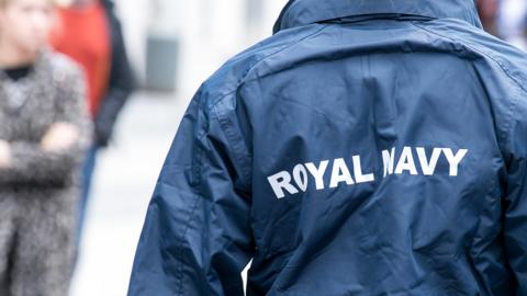 Rear view of woman wearing a Royal Navy uniform jacket