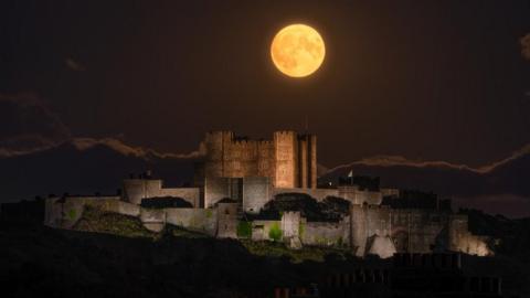 The blue supermoon lights up the night sky over Dover Castle, Kent