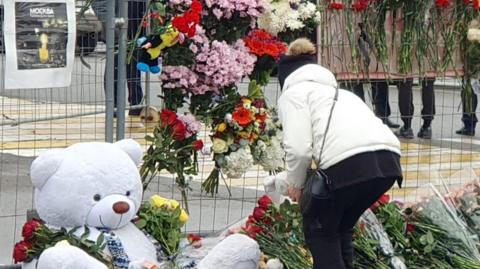 A teddy bear and flowers are left in memory of the victims of the deadly terrorist attack near Crocus City Hall in Krasnogorsk, Russia, 24 March 2024.