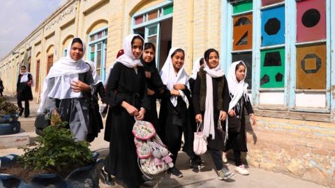 Afghan student girls arrive to attend lectures on the school in Herat, Afghanistan, on 6 March 2021