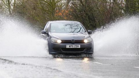 Car driving through floods