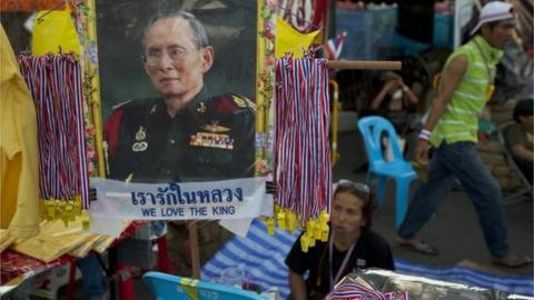 A portrait of revered Thai King Bhumibol Adulydej is displayed at a kiosk selling souvenirs in a cantral part of the city being occupied by anti-government protesters December 4, 2013 in Bangkok, Thailand.