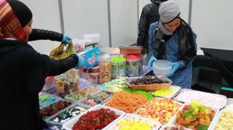 Women prepare food during the 35th annual meeting of the French Muslim community on March 30, 2018 at Le Bourget, north of Paris.