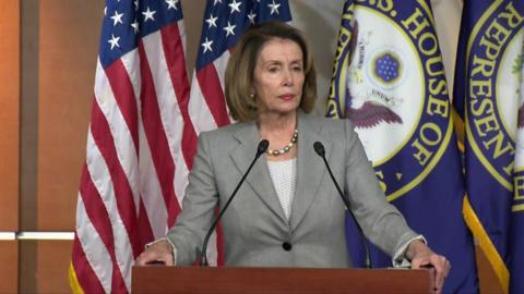 Nancy Pelosi at a podium