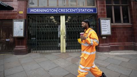 A man walks past Mornington Crescent tube station during a strike