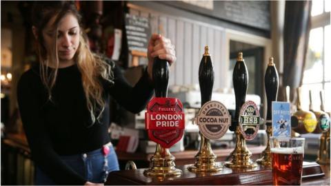 woman pouring pint