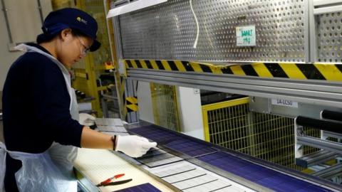 Woman in a solar panel factory