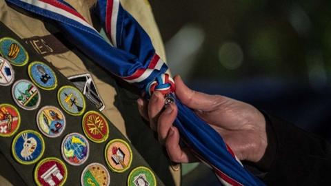 A scout receives their blue Eagle Scout neckerchief