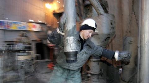 A worker changes pipes in the former Yukos and current Rosneft oil company drill platform in Priobskoye, western Siberia