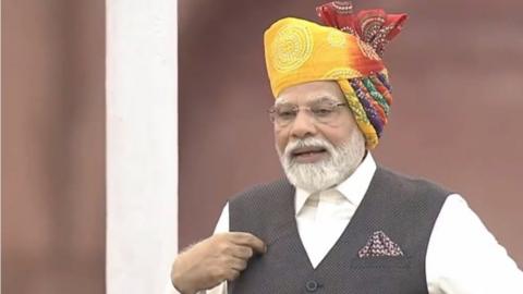 Narendra Modi in a yellow-red turban