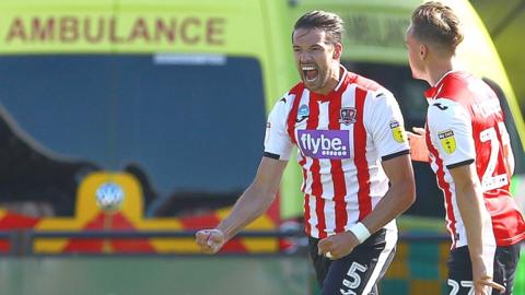 Aaron Martin of Exeter City celebrates scoring against Colchester