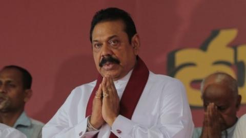 Former Sri Lankan president and parliamentary candidate Mahinda Rajapaksa (centre) prays along with this supporters during an election campaign in Colombo, Sri Lanka, Monday, 3 August 2015