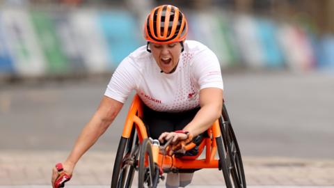 Eden Rainbow-Cooper crosses the finishing line at the Commonwealth Games
