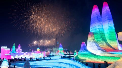 Harbin Ice and Snow Festival with fireworks in the background