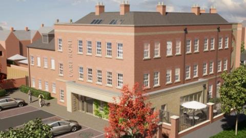 Artist's impression of a three-storey brick-built building. It is in a traditional Georgian style and has care home written on its side above its entrance. The building is side-on and on the left can be seen some parking, two cars and two people. On the right is a low brick wall with a seating area