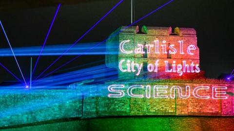 Carlisle Castle lit up in rainbow of light