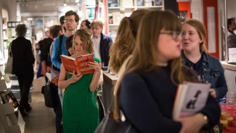 People queuing in a bookshop