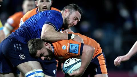 Leinster's Josh Murphy tackles Edinburgh's Adam McBurney