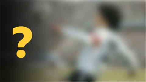 A blurred image of a footballer