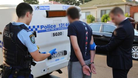 A man is arrested by police in Sydney