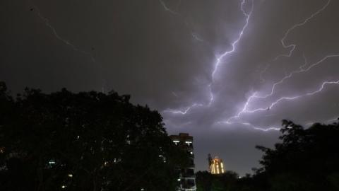 Lightning strikes over residential apartments during a thunderstorm on the outskirts of the Indian capital New Delhi on May 2, 2018