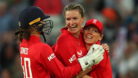 Lauren Bell, Amy Jones and Heather Knight celebrate wicket