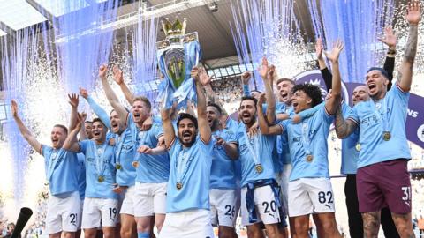 Manchester City lifting the Premier League trophy