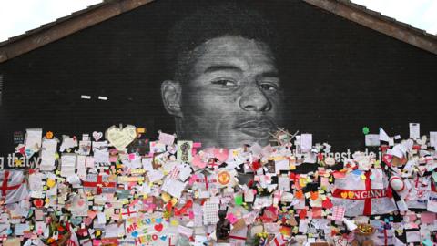 Messages are seen at the repaired mural of England footballer Marcus Rashford on the wall of a cafe on Copson Street, Withington on July 14, 2021