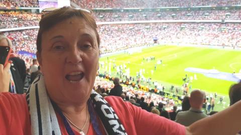 Carol Thomas cheering at Wembley Stadium