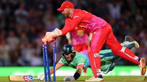 Oval Invincibles batter Tom Curran dives and makes his ground as Welsh Fire wicketkeeper Joe Clarke takes the bails off