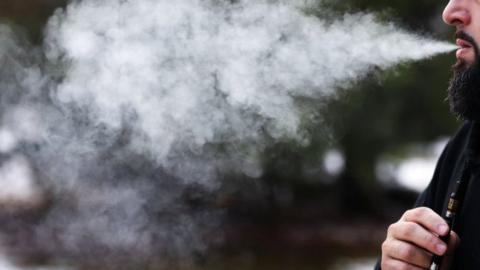 Man smoking with vape pen