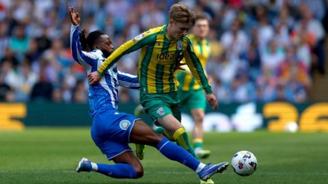 Ollie Bostock of West Bromwich Albion is fouled by Nathaniel Chalobah of Sheffield Wednesday