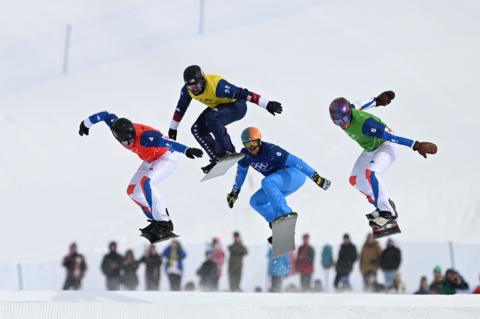 Snowboarders jump in unison