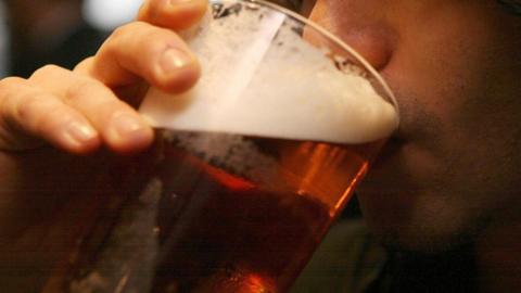 Man drinking pint of beer