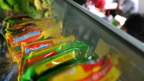 Instant noodle brands produced by the Indofood food company are displayed at a food stall in Jakarta on October 12, 2010