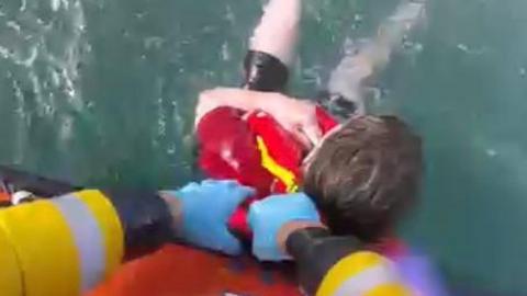 The boy being rescued