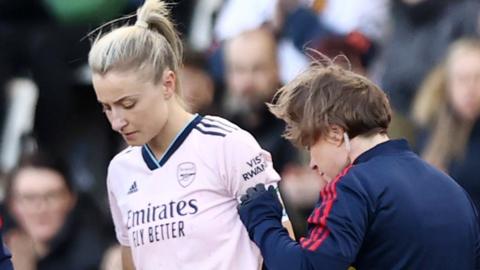 Leah Williamson receives medical treatment during the FA Women's Super League match between Manchester United and Arsenal