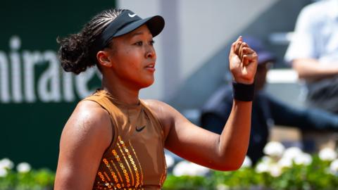 Naomi Osaka celebrates with a clenched fist