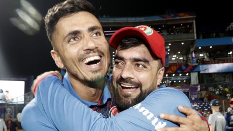 Afghanistan's Mujeeb Ur Rahman and Rashid Khan celebrate beating England