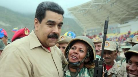 Venezuelan President Nicolas Maduro embraces members of the Bolivarian militia during a military training in Caracas on May 21, 201