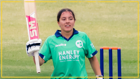 Amy Hunter celebrates after hitting her century for Ireland in Harare