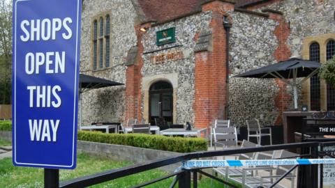 A new 'shops open' sign outside the Mill pub in the Maltings