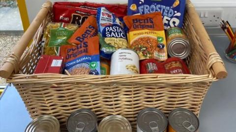 Basket of tinned and packaged food on a table within the staff area of Milton Keynes Hospital