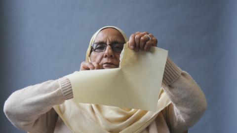 By ripping the paper Razia is showing that the legislation did nothing to prevent the hatred she faced.