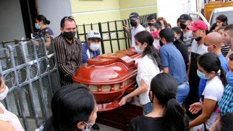Family members bid farewell to one of the victims of the murder of eight people in Samaniego, Colombia, 16 August 2020.