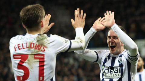 West Brom players high five after goal