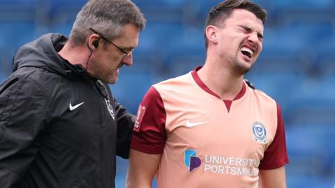 Portsmouth defender Regan Poole (right)