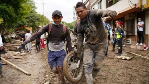 People remove a motorcycle