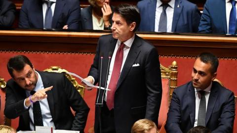Italy's PM Giuseppe Conte addresses Senate flanked by Matteo Salvini (L) and Luigi Di Maio (R)