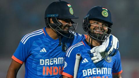 Mukesh Kumar (right) and Rinku Singh (left) celebrate hitting the winning runs in the first T20 v Australia